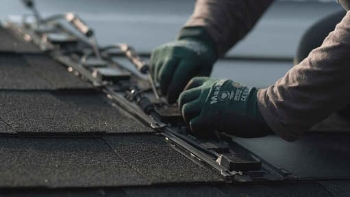 Installer hooking up GAF Timberline solar roof shingles
