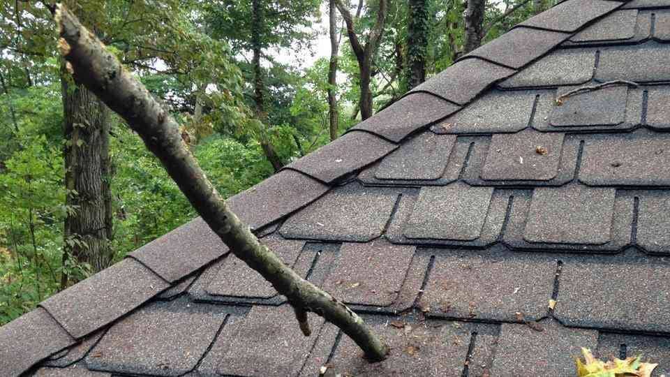 damaged roof with stick in it.