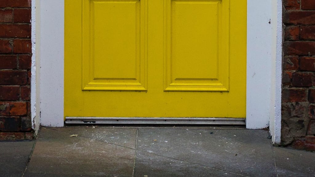 yellow door with door sweep