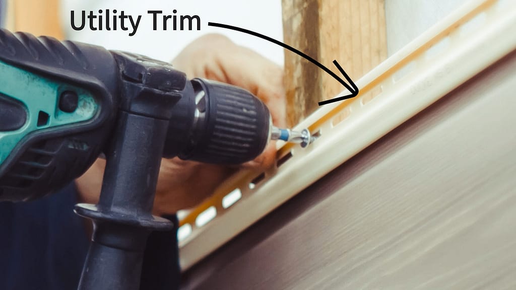 A person putting a screw on a utility trim