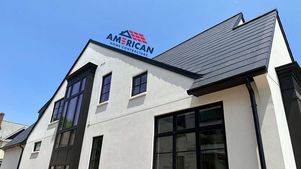 Tesla solar roof with American Home Contractors logo