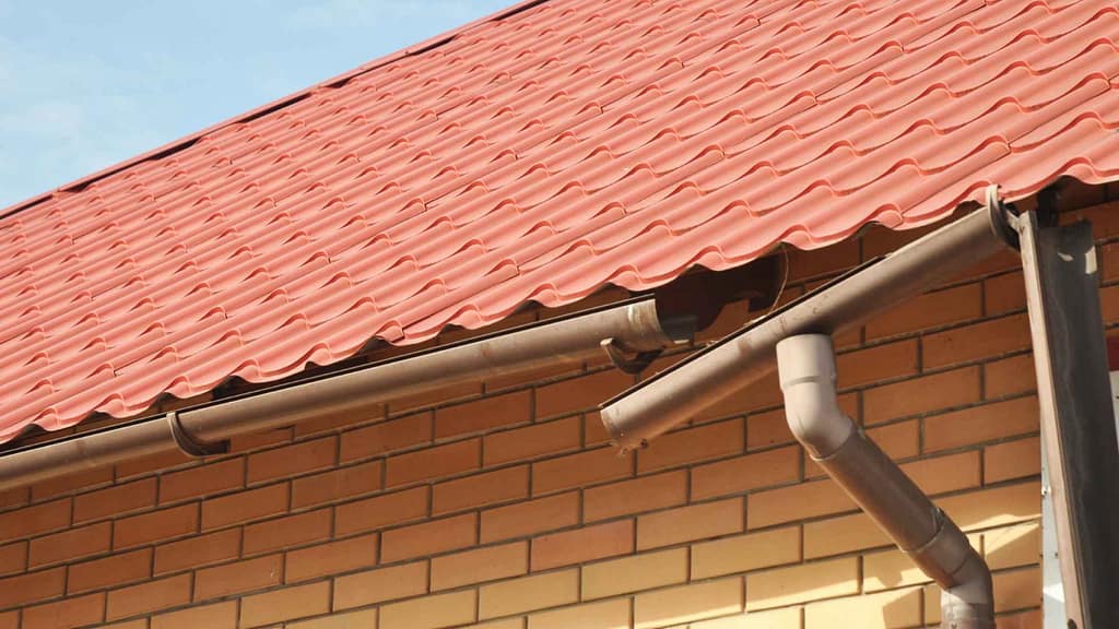 broken gutter hanging from roof