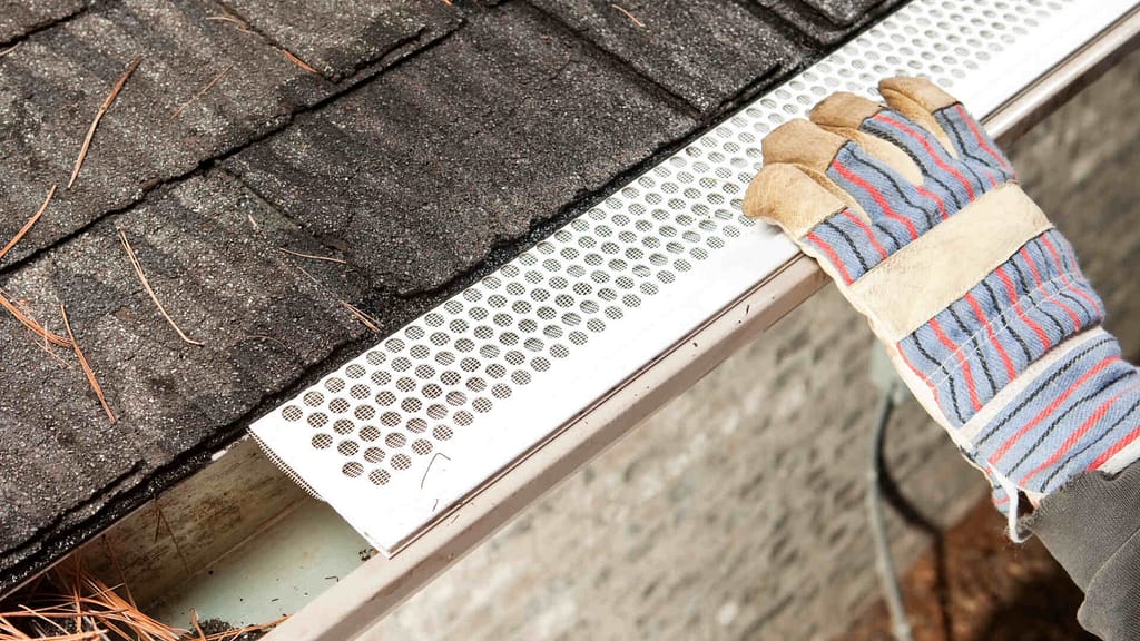 person installing a gutter guard