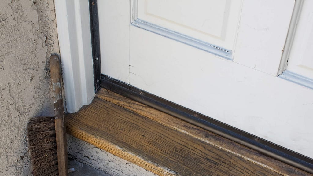 exterior door with threshold to seal the gap