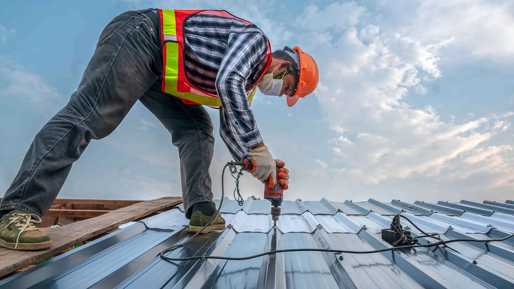 Roofer installing a new metal roof