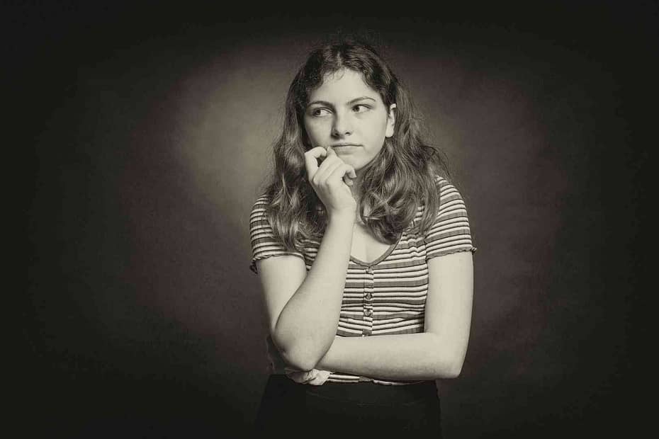woman with hand to face thinking
