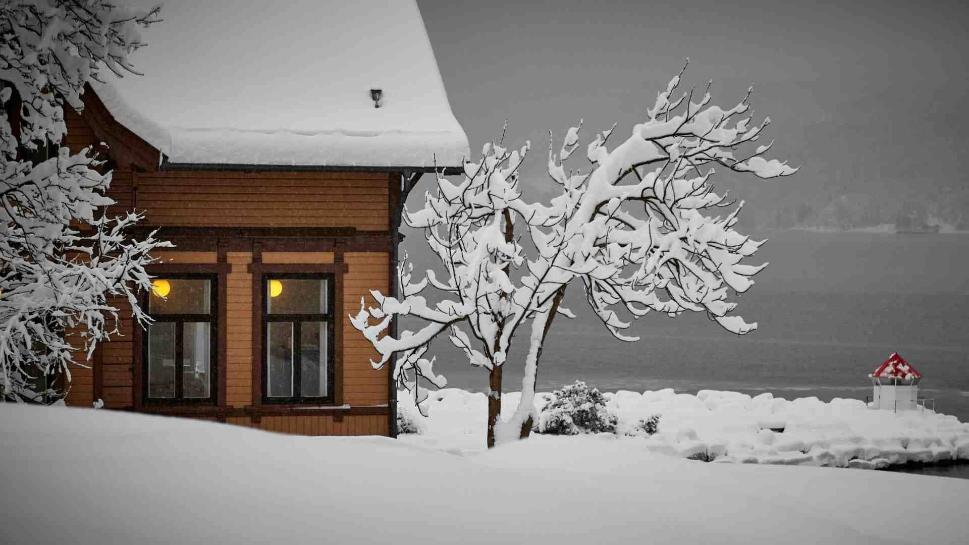 Home with roof covered in snow