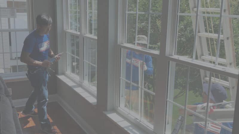 Two home contractors working on a home in Virgina replacing windows.