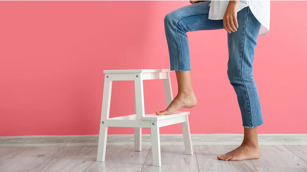Person using a step stool