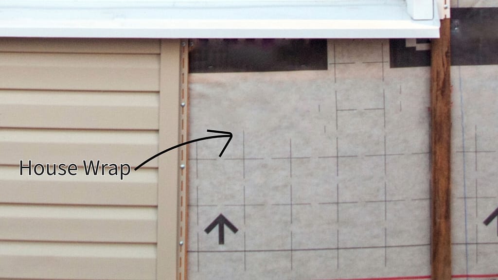 Unfinished vinyl siding installation with house wrap